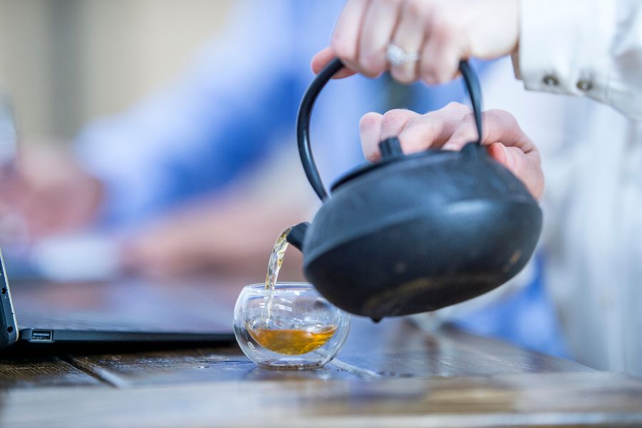 Someone pouring tea from a tea pot